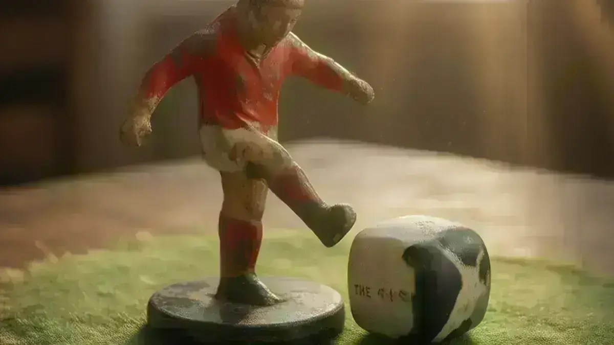 Tipp-Kick figure with its hinged kicking leg and the two-tone rounded-cube ball